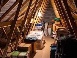 Cluttered attic before cleanup and insulation