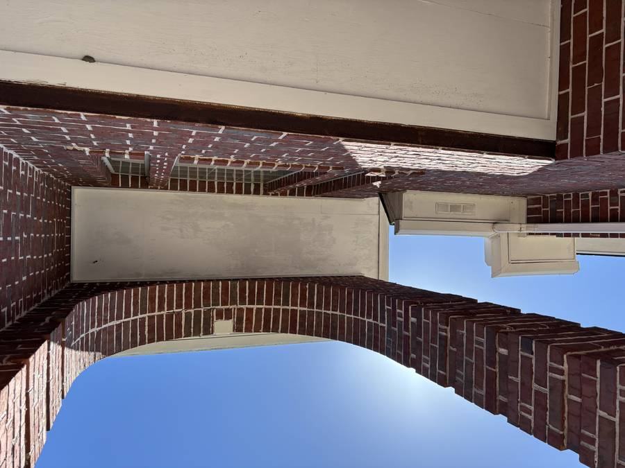 Exterior before — gable with ivy