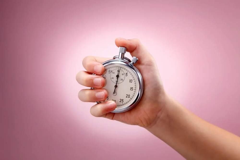 Hand holding a stopwatch